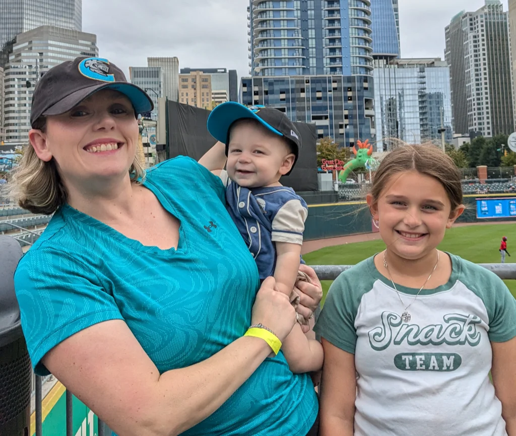 Hailey with her mother and little brother at a baseball stadium